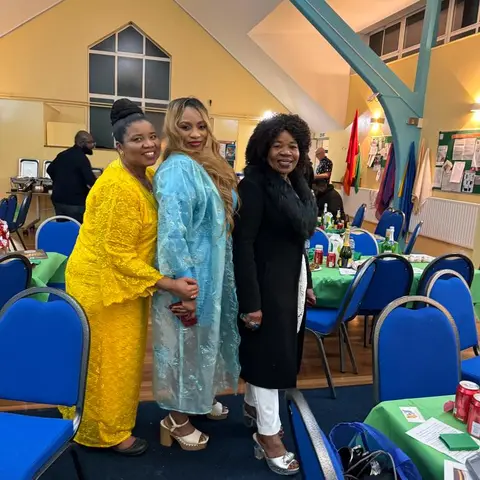 A man receiving his certificate from the presenter, both smiling and holding the certificate together.