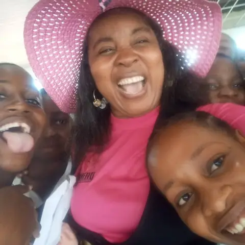 A fun selfie of four foundation team members laughing and pulling faces together at the International Day of the Girl Child event.