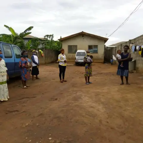 Three women standing together in front of a Leadership Foundation banner outdoors.