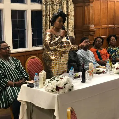 A crowd of women and children seated during a community distribution program.