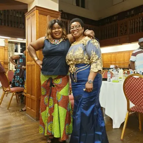 Audience members seated in a meeting room, focused on a presentation.