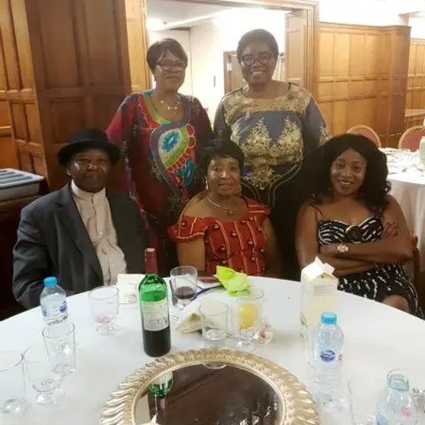 People seated in rows at a workshop, with some taking notes.