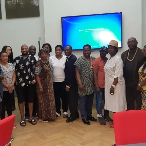 A group of volunteers and staff standing together with an AFSF banner at an outdoor site.